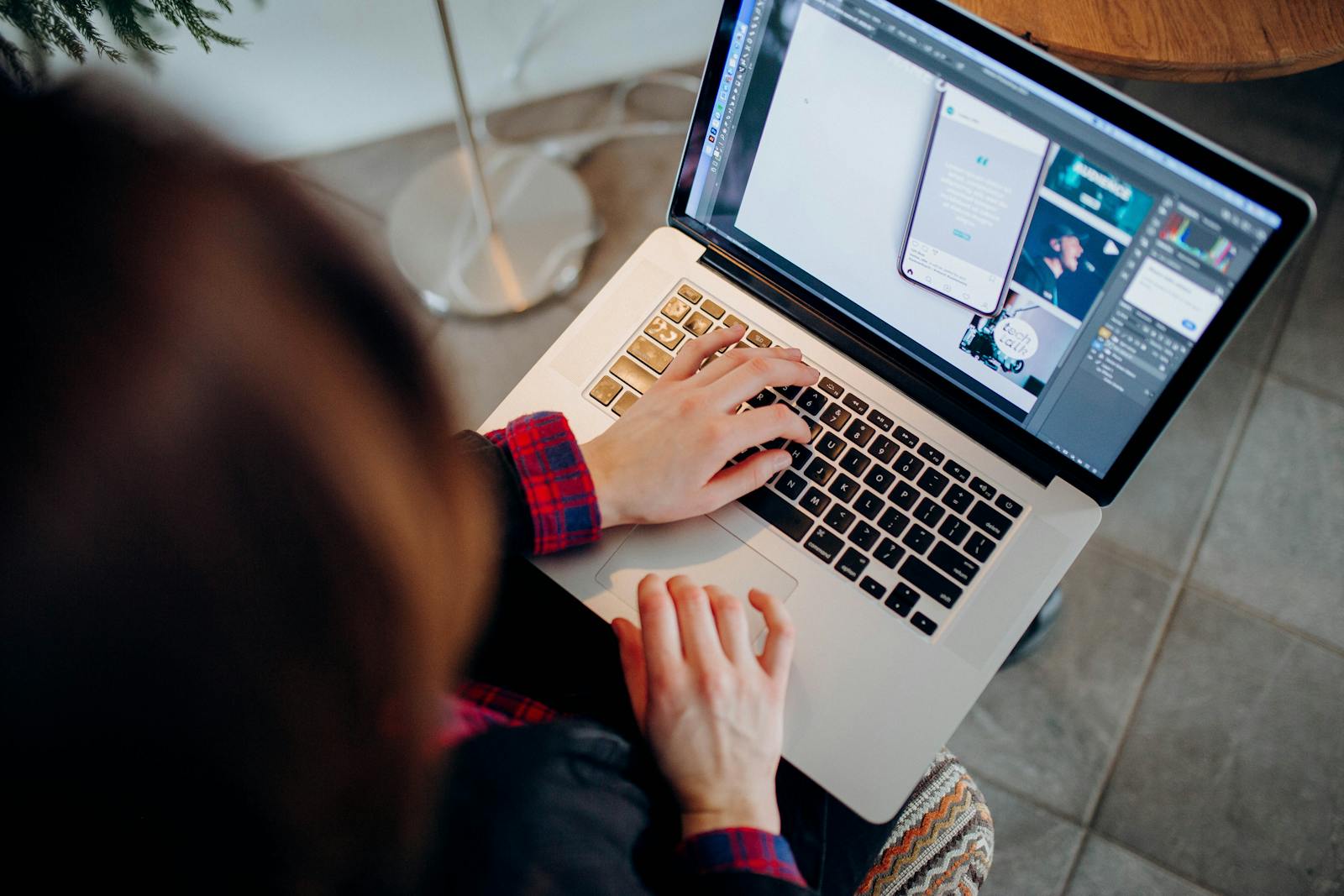 Designer working on a laptop with creative software open