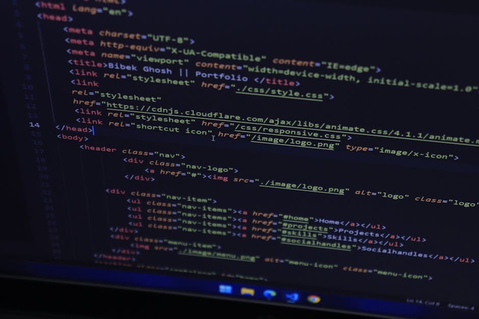 Close-up of code displayed on a computer screen in a dark environment